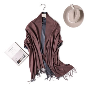 Detail of double-sided cashmere-feel scarf in dark brown and grey with fringe edges