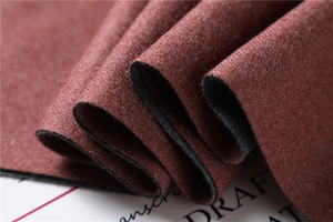 Close-up of thick double-sided faux cashmere scarf showing red and black fabric texture
