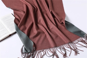Close-up of dual-color brick red and grey cashmere scarf with elegant fringe detail