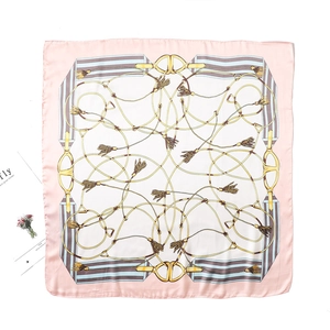 Detail of pink and white silk square scarf with vintage equestrian and chain patterns