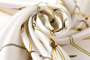 Close-up of elegant silk square scarf with nautical rope patterns and satin texture