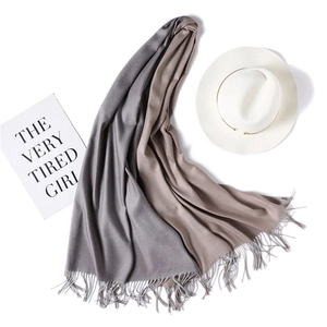 Close-up of two-tone gray and coffee cashmere scarf with long fringe details