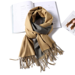 Detail of khaki and gray reversible cashmere-like scarf with soft fringe tassels