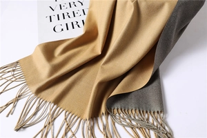 Close-up of double-sided cashmere-feel scarf with yellow and grey tones and fringe edge