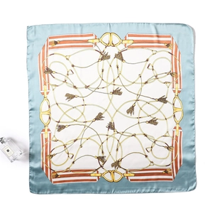 Detail view of square silk scarf with equestrian horse bit and rope pattern in blue and gold