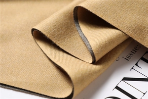 Detail of premium double-sided cashmere-style fabric in mustard yellow and dark grey