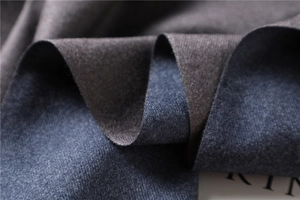 Close-up of double-sided cashmere-like scarf fabric in charcoal grey and blue-grey tones