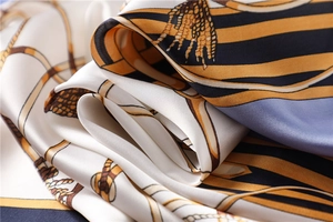 Macro shot of silk square scarf featuring nautical chain patterns and elegant fabric texture