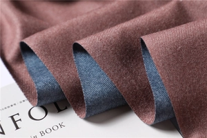 Close-up of double-sided cashmere-style scarf showing rich red and navy blue textures
