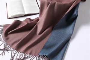 Detailed view of bicolor brown-red and grey-blue cashmere scarf with soft tassel fringe