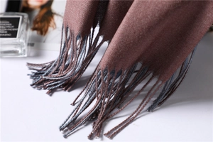 Close-up of terracotta pashmina shawl with tassel edge and twill woven texture