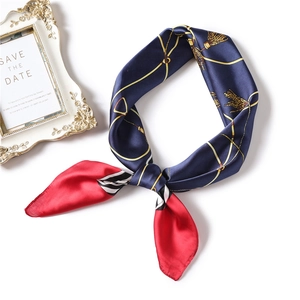 Detail of silk square scarf with golden chain print and navy blue finish for professional use