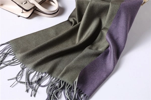 Close-up of dual-tone cashmere-like scarf with hand-woven tassels in green and purple