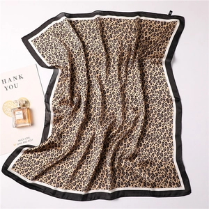 Macro detail of leopard print silk scarf with luxury smooth texture and border