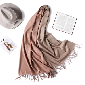 Detail of double-sided cashmere-like scarf with fringe tassels and elegant styling props