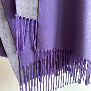Detail shot of purple cashmere feel scarf with fringe tassels and gray reverse side