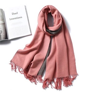 Detail of pink and dark grey double-sided scarf with fine tassel fringe and soft texture