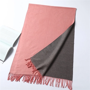 Detail of double-sided solid color scarf with soft fringes and cashmere-like texture