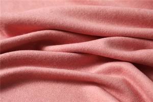 Macro shot of soft pink cashmere-like fabric showing fine texture and thick warm fibers