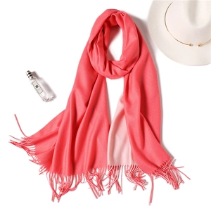 Detail of coral pink pashmina scarf with soft fringes and fine cashmere-like texture
