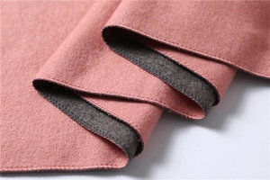 Detail of double-sided cashmere-like scarf in dusty rose pink and charcoal grey texture