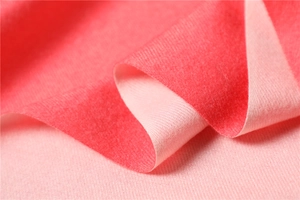 Macro shot of double-sided pink cashmere-like scarf with soft twill texture and warm feel
