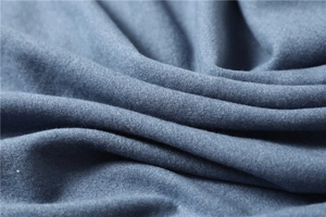 Macro view of navy blue thick cashmere-like fabric showing soft texture and fine grain