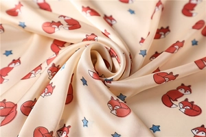 Macro shot of satin silk scarf with cute cartoon fox print and glossy fabric texture