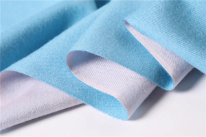 Detail of soft sky blue and white reversible cashmere-feel scarf with plush texture