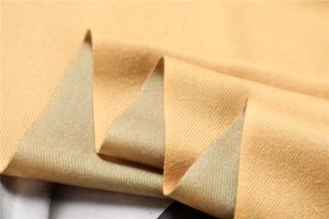 Close-up of double-sided twill cashmere-like scarf fabric in warm ginger yellow color