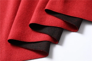 Detail shot of heavy double-sided cashmere-like scarf with red and black wool texture