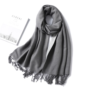 Detail of dark grey fringe scarf with thick cashmere texture and soft tassels