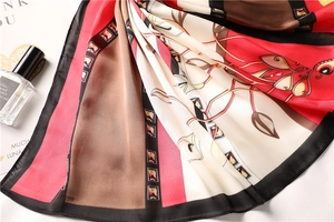 Detailed texture of 70cm faux silk scarf with red, beige and brown floral pattern