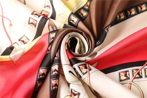 Macro shot of silk satin scarf with vintage geometric patterns and vibrant color block design
