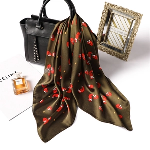 Olive green square silk scarf featuring red fox and gold star prints with satin finish