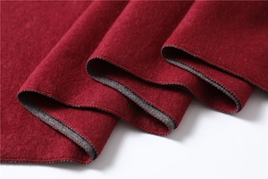 Close-up of thick red faux cashmere scarf showing soft texture and double-sided grey contrast