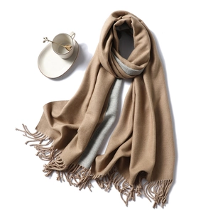 Detail view of double-sided camel and grey winter scarf with soft fringe edges