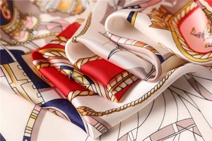 Detailed close-up of luxury silk scarf with nautical ropes and chains print texture