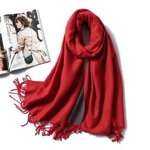 Detail of red and taupe reversible scarf with soft cashmere texture and fringe