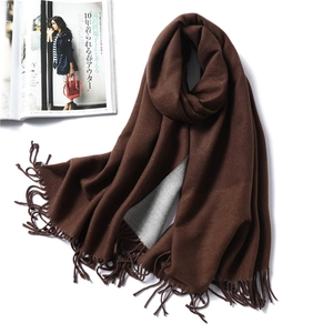 Macro detail of thick coffee brown cashmere feel scarf with fringe edges and soft texture