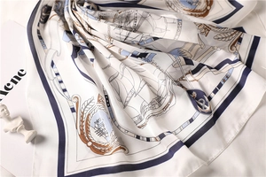 Detail of nautical silk square scarf with anchors and sailboats in ivory and navy blue