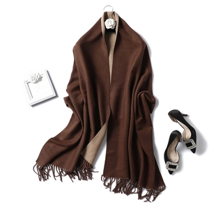 Detail of double-sided cashmere-like scarf in dark brown and camel with soft fringes