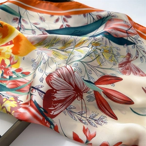 Macro shot of tulip silk scarf showing smooth texture and vibrant floral print details