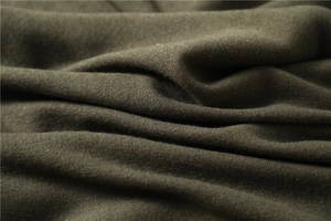 Macro view of dark olive green cashmere-like fabric showing soft texture and fiber details