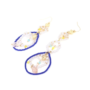 Bohemian handmade beaded hoop earrings with colorful crystals and pearls on white background