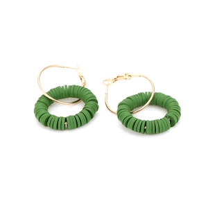 Bohemian gold hoop earrings with handmade green polymer clay beads on white background