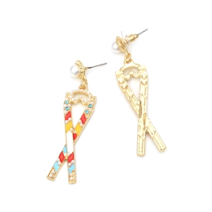Close-up of colorful enamel ribbon earrings with pearls and crystal accents on white background