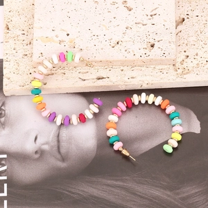 Colorful C-shaped beaded hoop earrings with gold spacers for bohemian fashion look