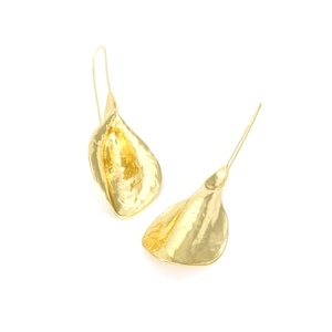 Detail of vintage gold flower earrings with irregular petals and artistic curved hooks