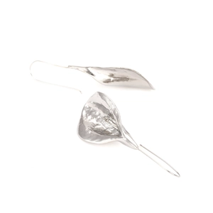 Detail of silver calla lily earrings with a handcrafted hammered metal texture finish